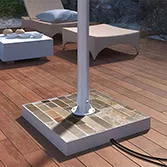 Stone base mount for outdoor TV with colored slate base and stainless steel pole in a patio in Oman.