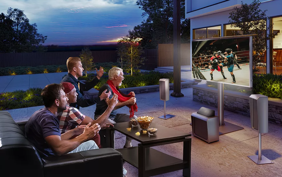 Outdoor TV with a sound-wave audio system and a group of friends watching in Qatar.