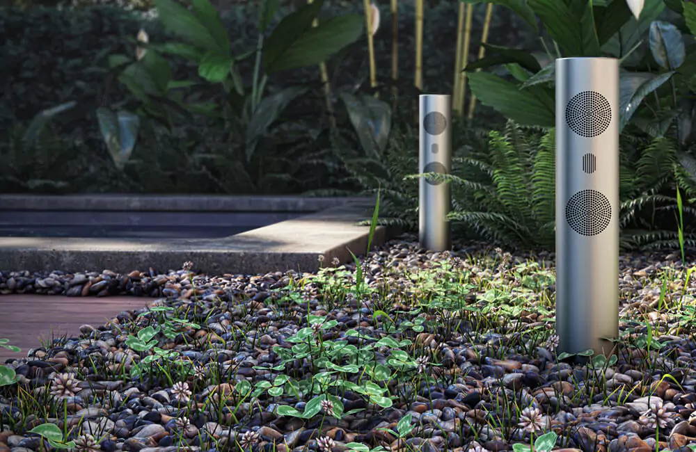 A backyard beautiful garden with two outdoor weather-resistant cylinder speakers in Qatar.