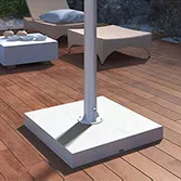 Outdoor TV stone base mount with a stainless bar and a white granite base on a veranda in Ajman.